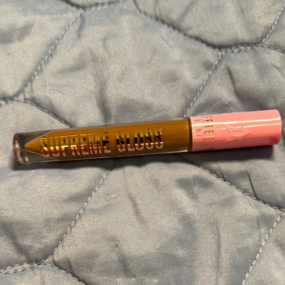 Supreme Gloss by Jeffree Star - in Shade Top Shelf, a creamy brown color